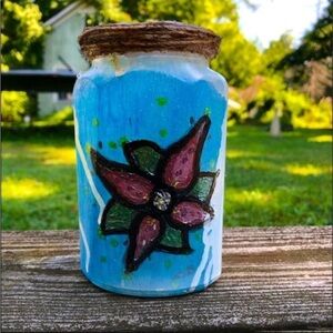 Mason jar with a flower painted on it
